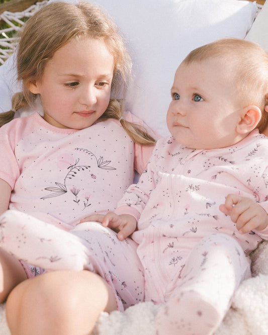 Printed Organic Cotton One-Piece Pajama Small Pink Flowers On Pale Pink Background-1